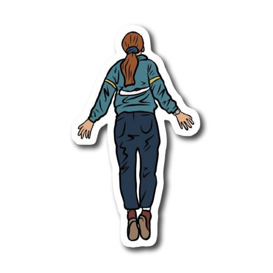 Girl in tracksuit levitating with arms outstretched, viewed from behind